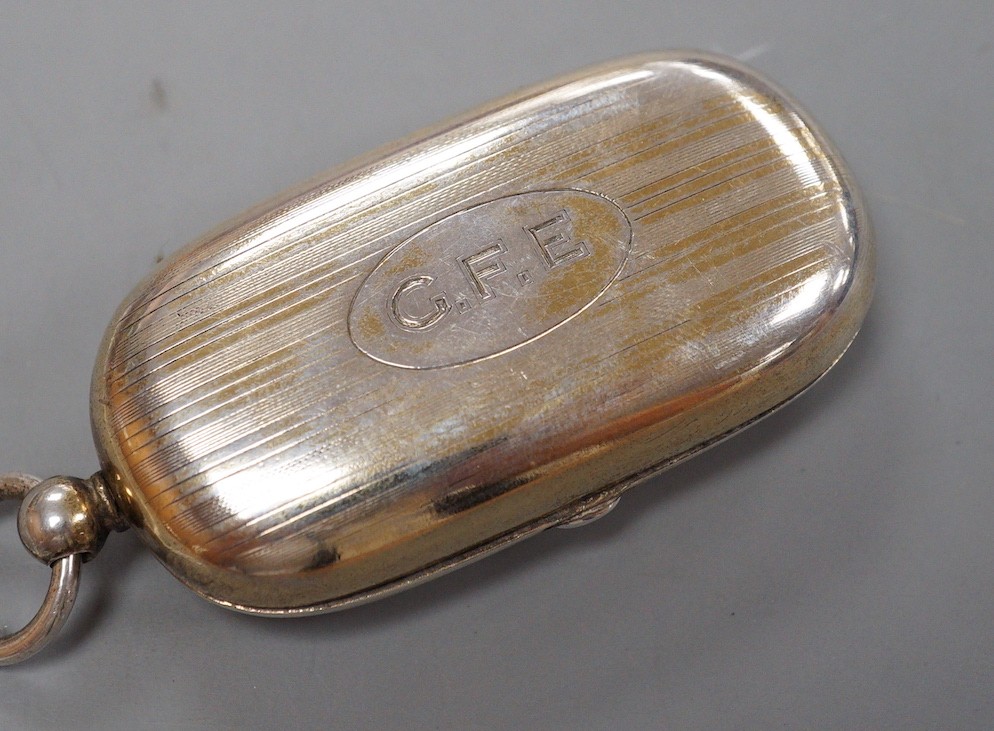 A George V silver silver gilt oval sovereign/half sovereign case, with engraved initials, Goldsmiths & Silversmiths Co Ltd, London, 1910 (gilding worn), 66mm.